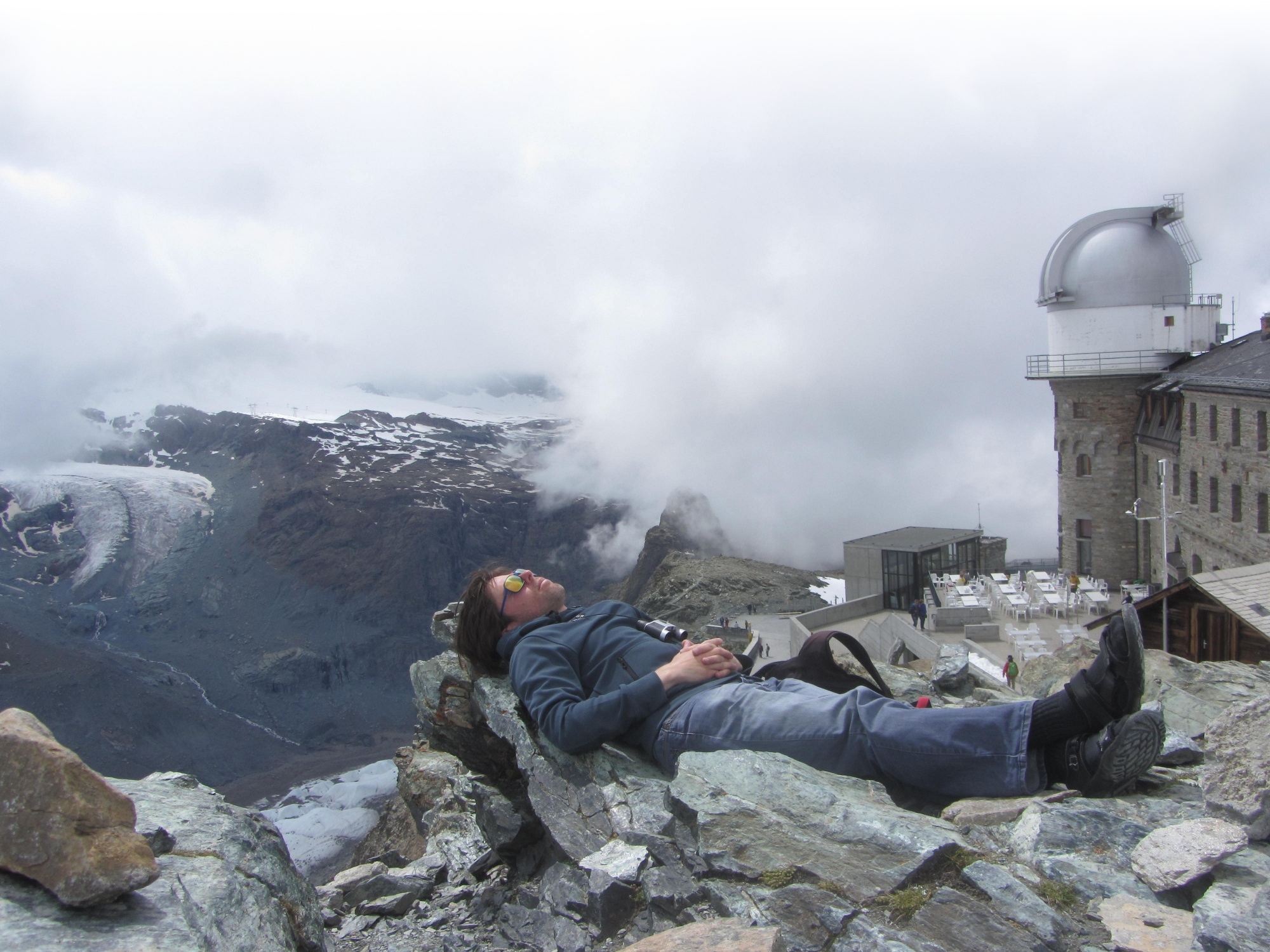 lying on the rocks with a view on the Gornergrat glaciers after reaching them on foot